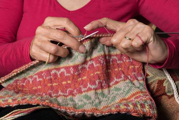 hands knitting a Fair Isle pattern