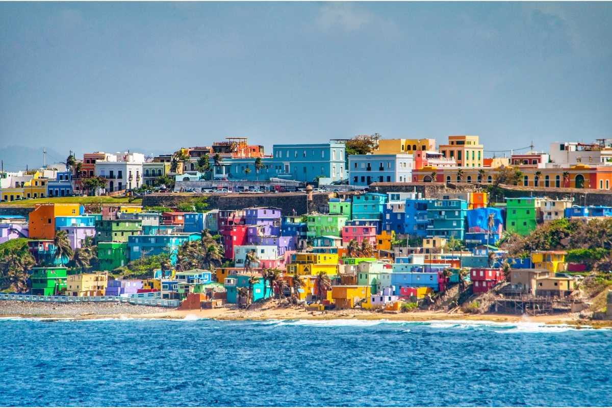 Bright colorful houses line the hills overlooking the beach in San Juan