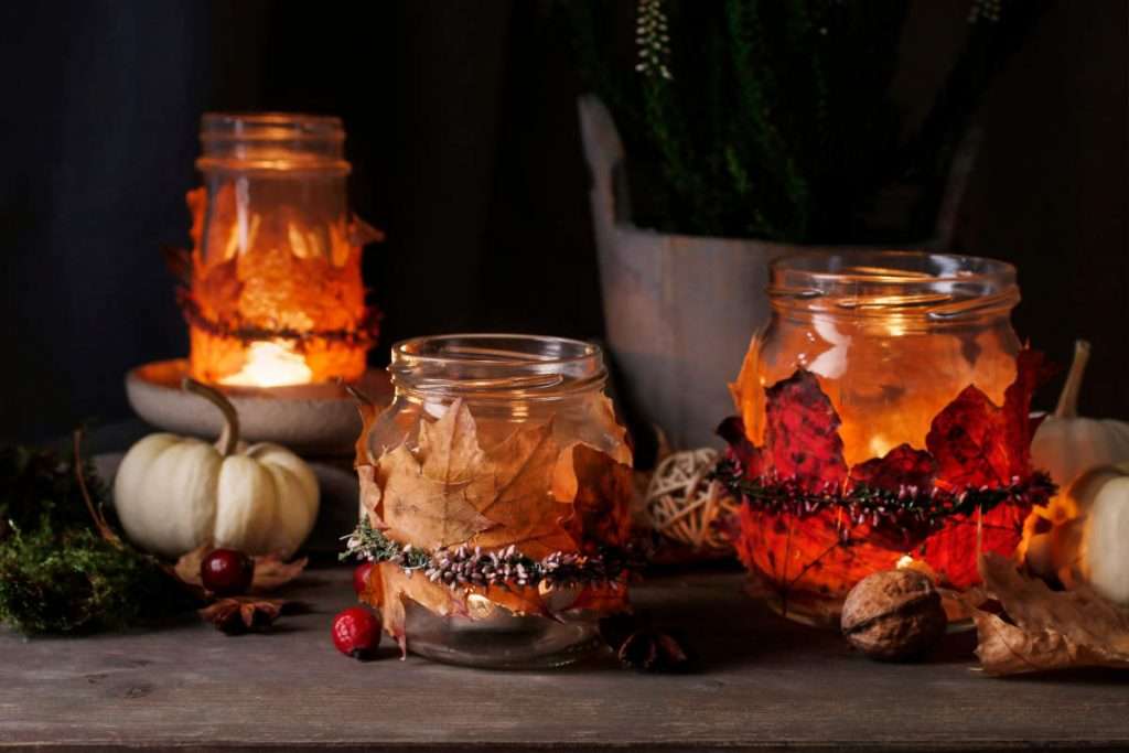 Autumn lantern jars decorated with colorful autumn leaves.