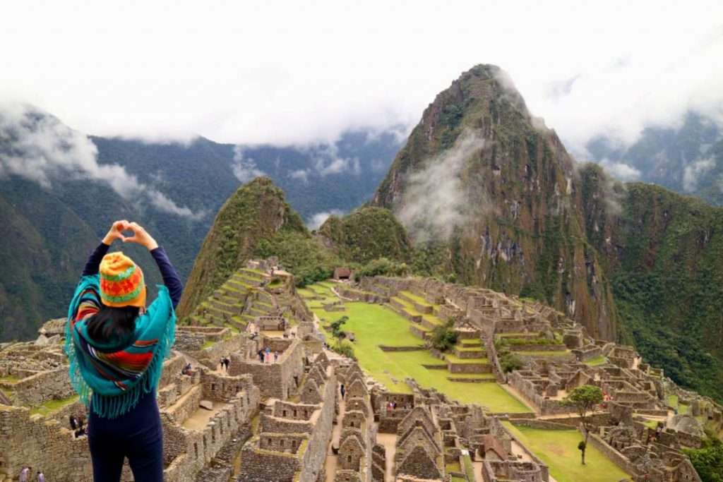 Female dressed in Alpaca Poncho at Machu Picchu