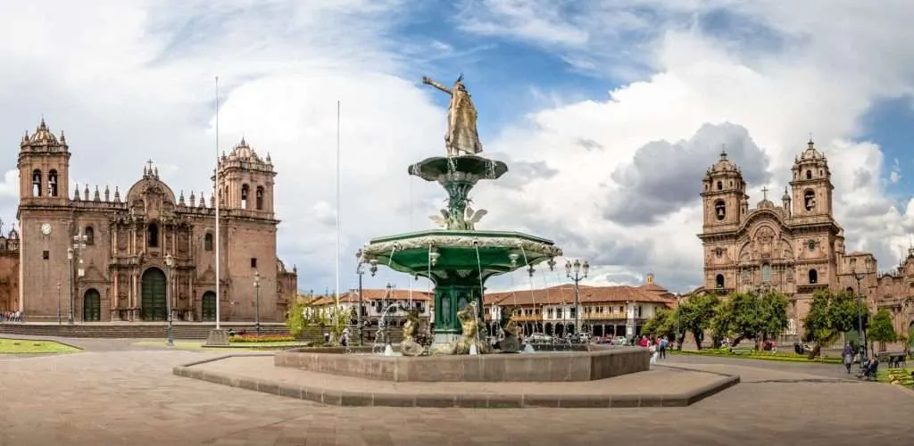 Panoramic view of Plaza de Armas with Inca fountain, Cathedral and Compania de Jesus Church - Cusco